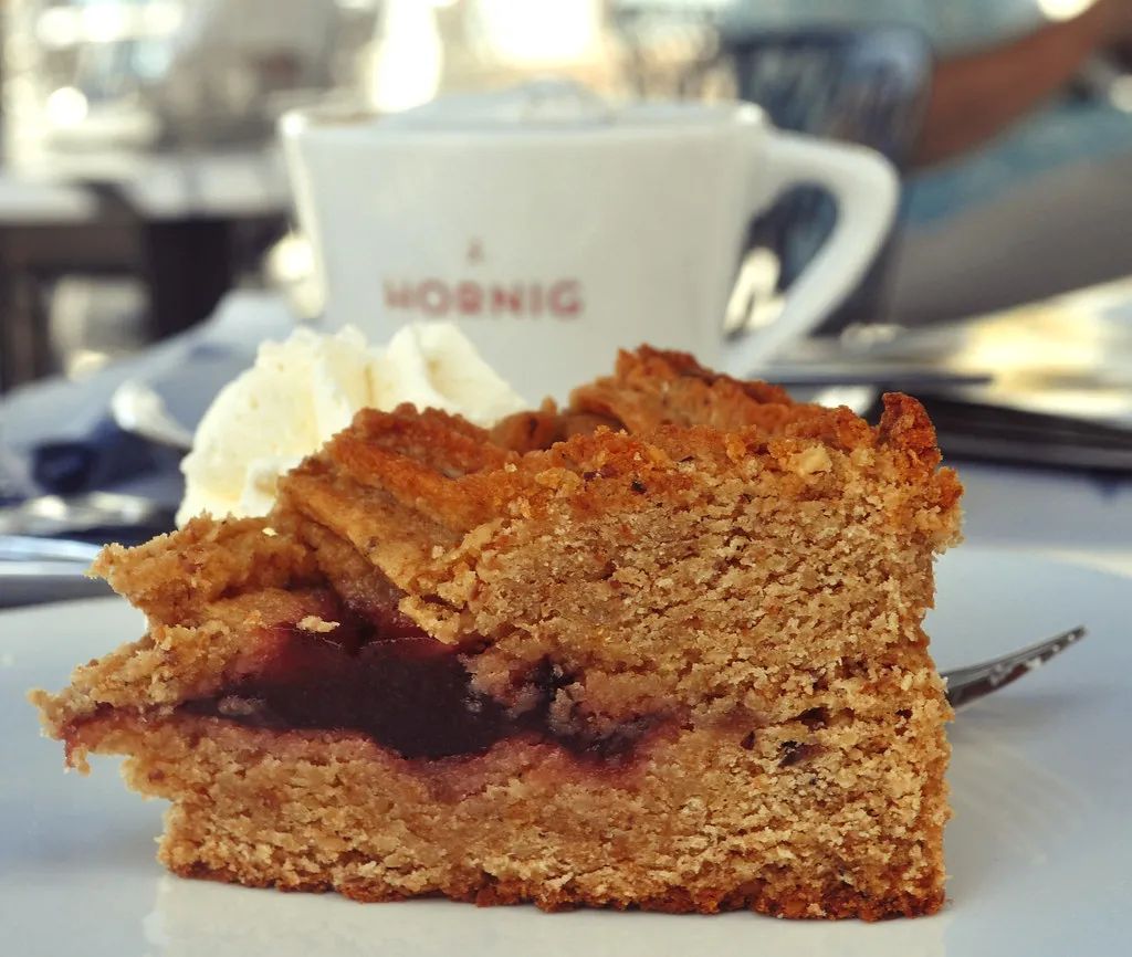 A slice of cake and a coffee on a café table