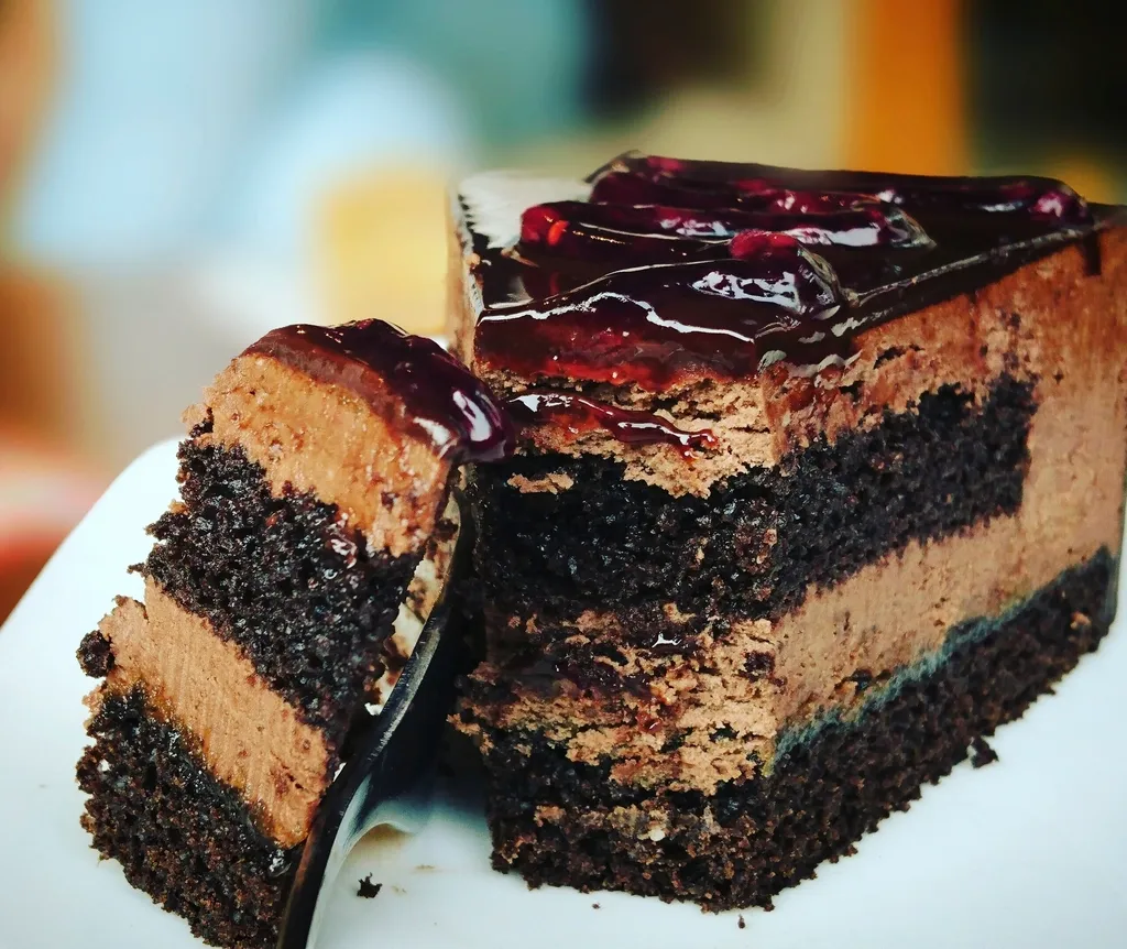 A slice of layered chocolate cake