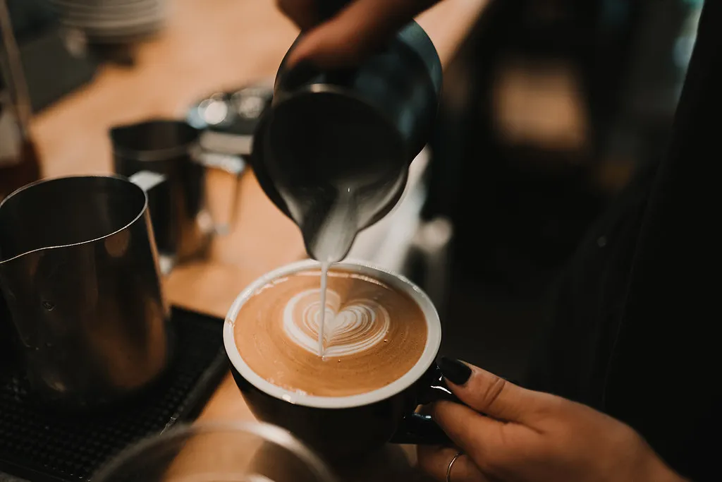 A flat white with a heart poured into the crema